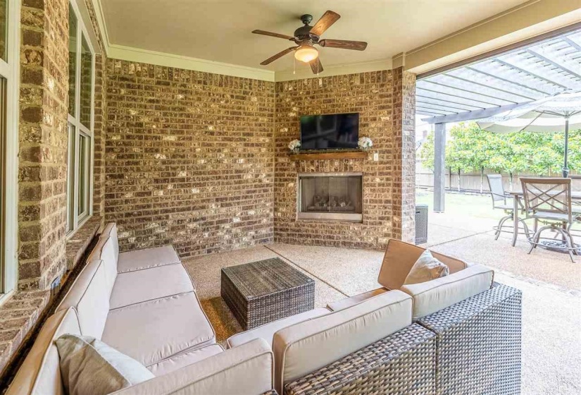 View of patio / terrace with a pergola, ceiling fan, and an outdoor living space with a fireplace