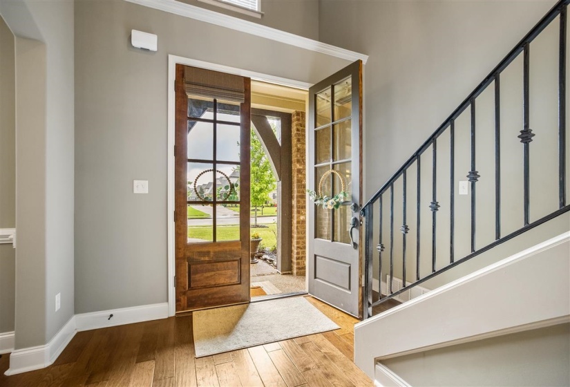 Foyer entrance featuring hardwood / wood-style floors and baseboards