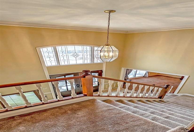 Stairway featuring plenty of natural light and a high ceiling