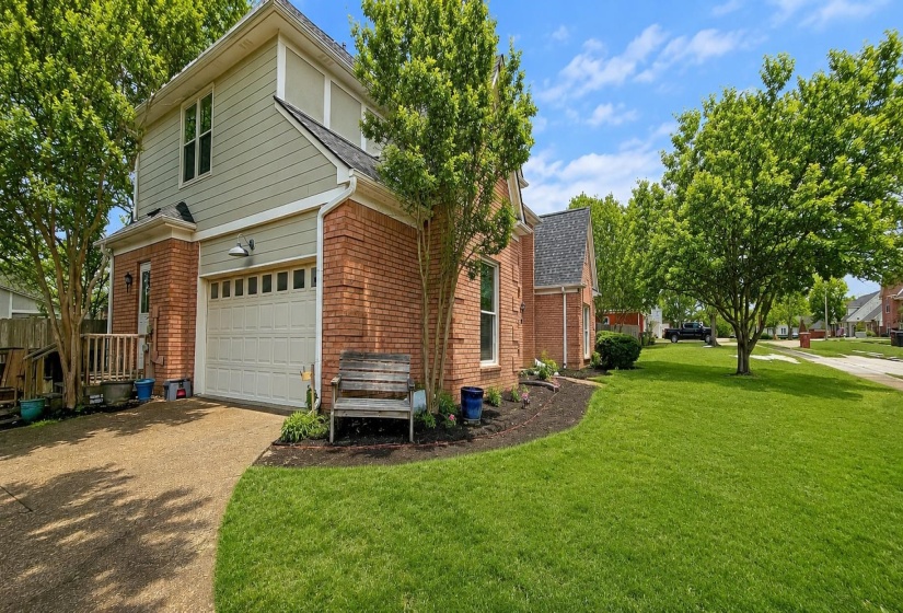 View of front of property featuring concrete driveway, brick siding, a garage, and a shingled roof