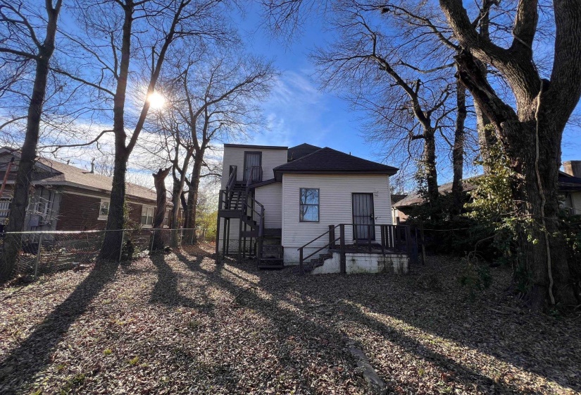 Back of property featuring stairs