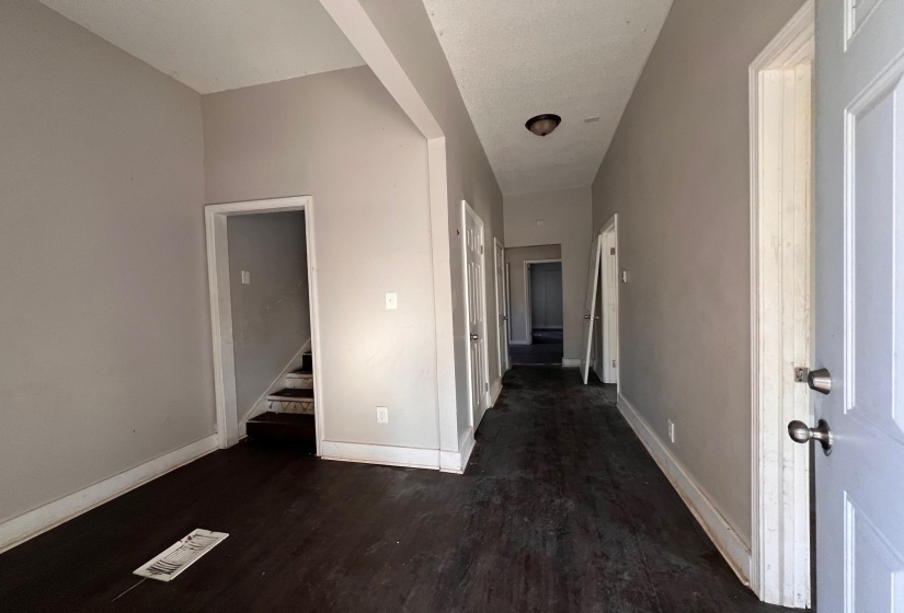 Corridor with dark wood-type flooring and stairway