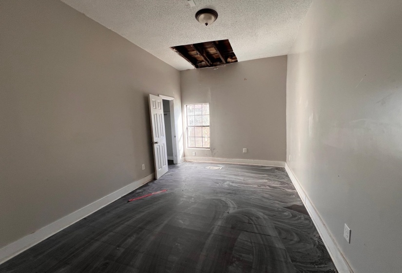 Spare room with baseboards and a textured ceiling