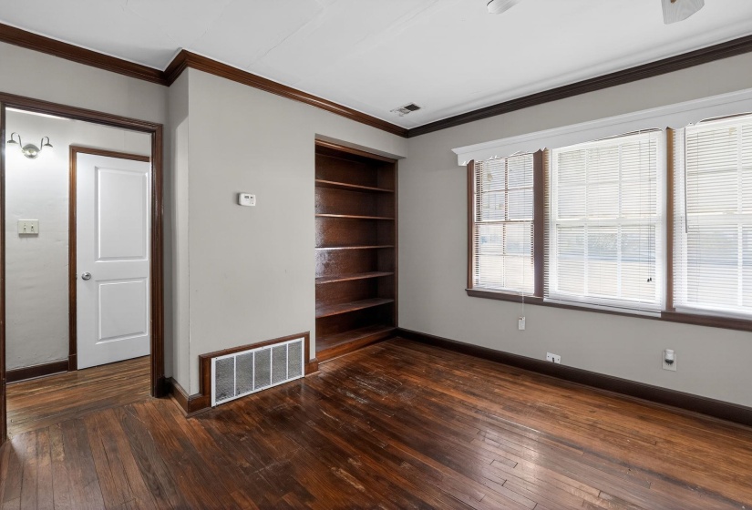 Unfurnished room featuring crown molding and dark wood-style floors