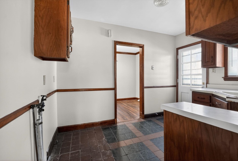 Kitchen featuring light countertops and brown cabinetry
