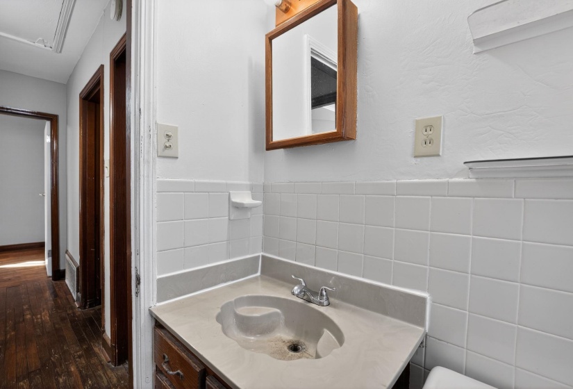 Bathroom with vanity and dark wood-style flooring