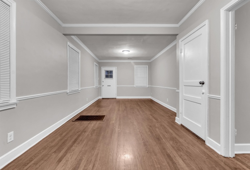 Empty room with wood finished floors and crown molding