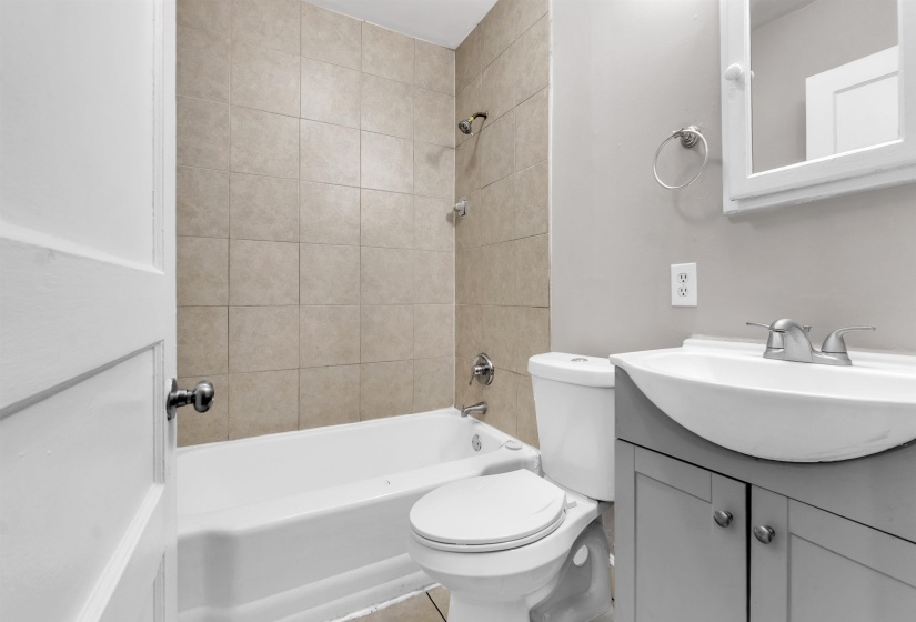 Bathroom with shower / washtub combination and vanity