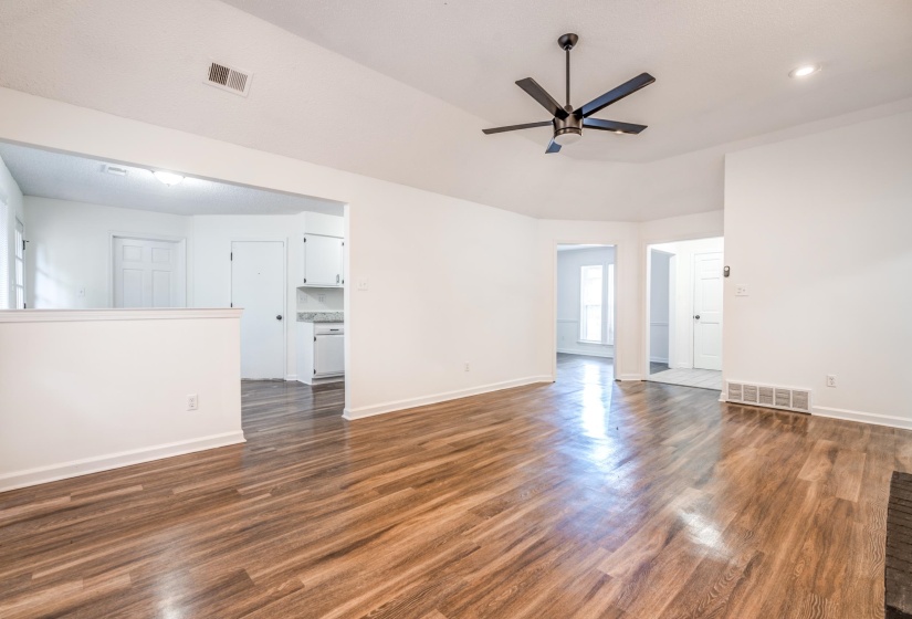 Empty room featuring dark wood-style floors and ceiling fan