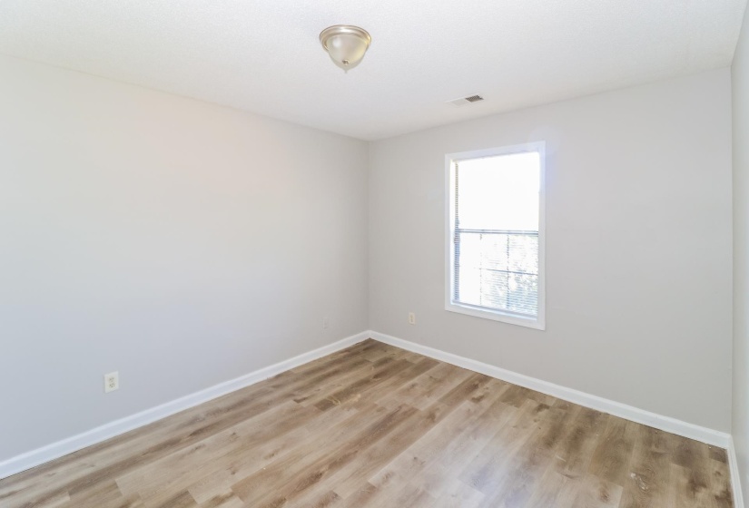 Unfurnished room featuring baseboards and light wood finished floors