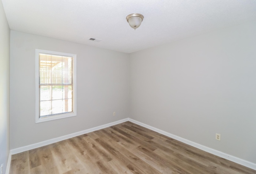 Empty room with light wood finished floors and baseboards