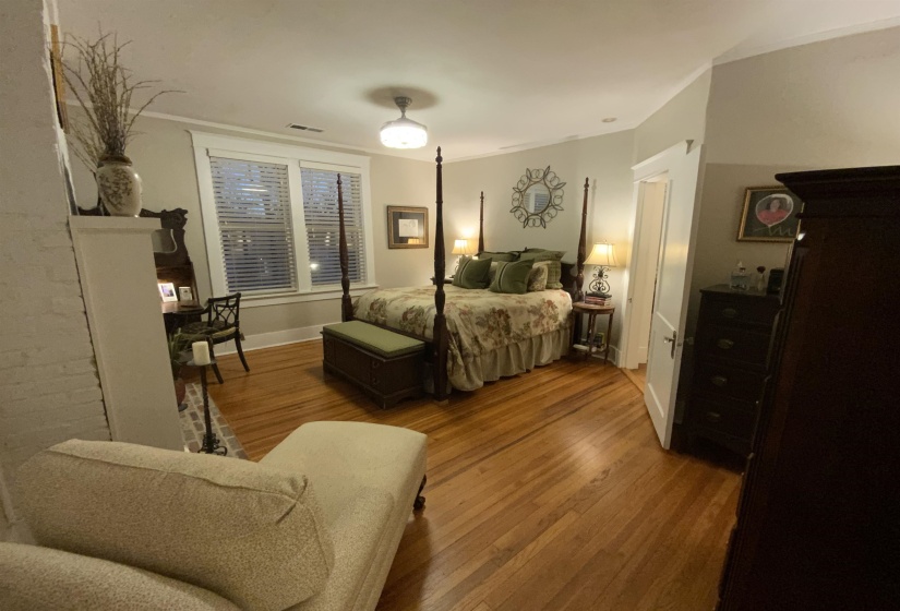 Bedroom featuring wood-type flooring and baseboards
