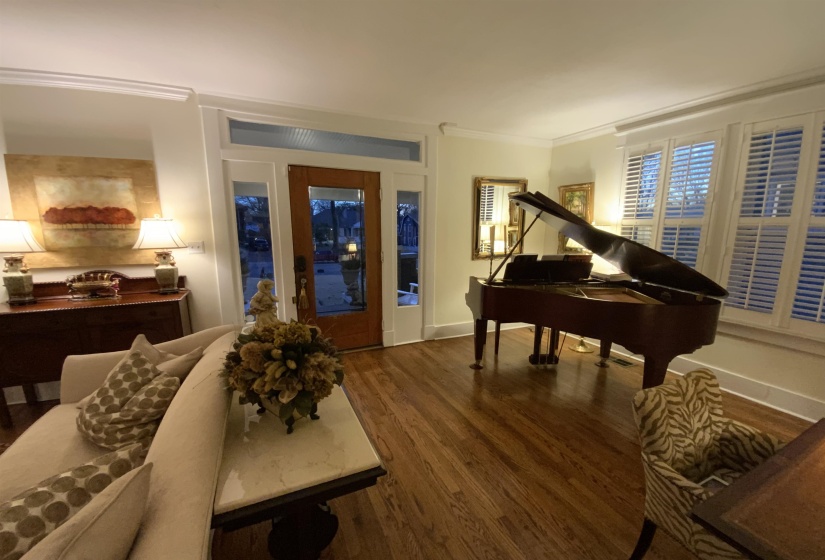 Foyer entrance with wood finished floors and ornamental molding