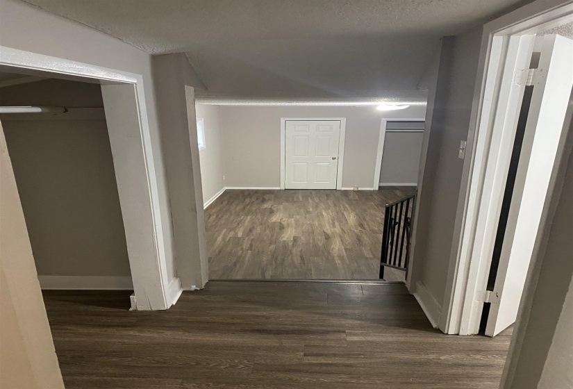 Hall with dark wood-style floors and a textured ceiling