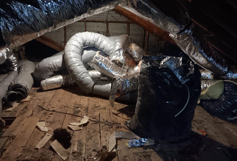 Unfinished attic featuring heating unit