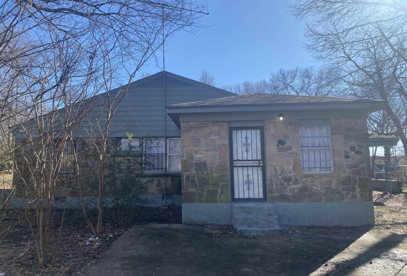 View of front of house with stone siding and entry steps