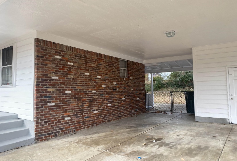 View of patio / terrace with a gate and an attached carport