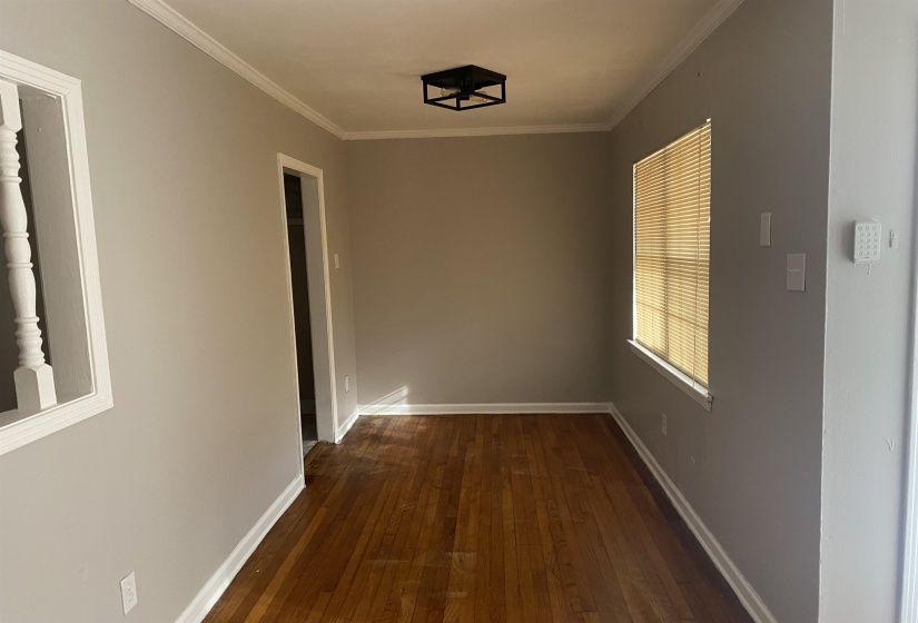 Hallway featuring dark wood-style flooring and ornamental molding