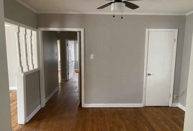 Hallway featuring dark wood-style floors and ornamental molding