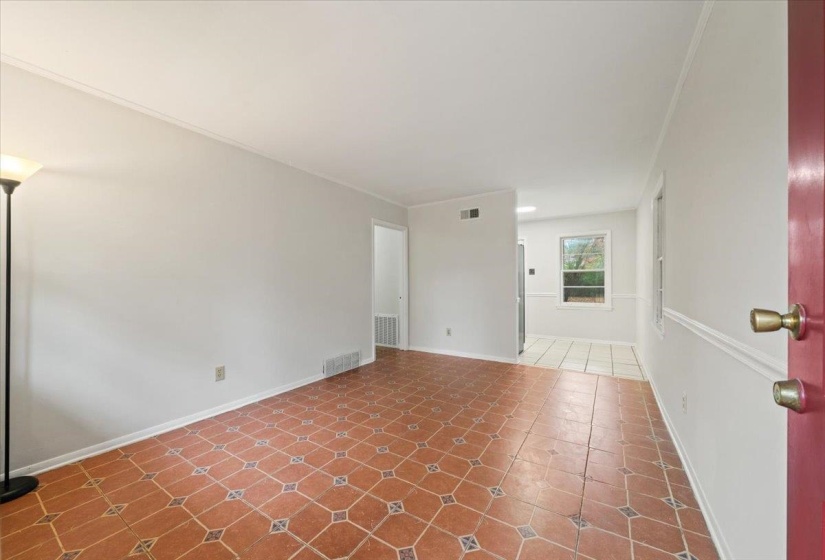 Empty room with ornamental molding and baseboards