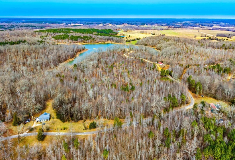 Aerial view of a heavily wooded area and a large body of water