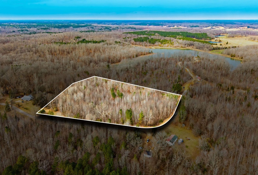 Aerial overview of property's location with property boundaries highlighted and a nearby body of water