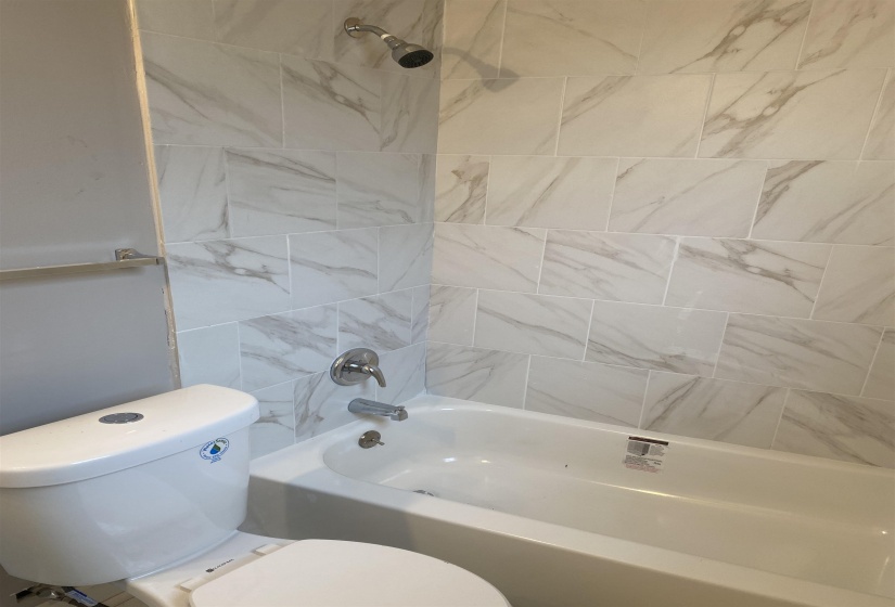 Full bath with toilet and shower / tub combination