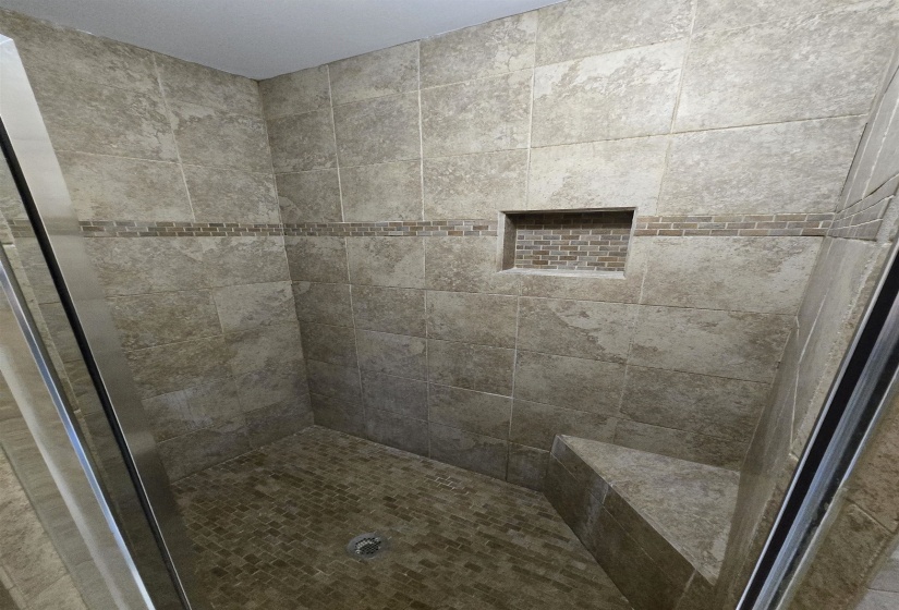 Bathroom featuring a tile shower