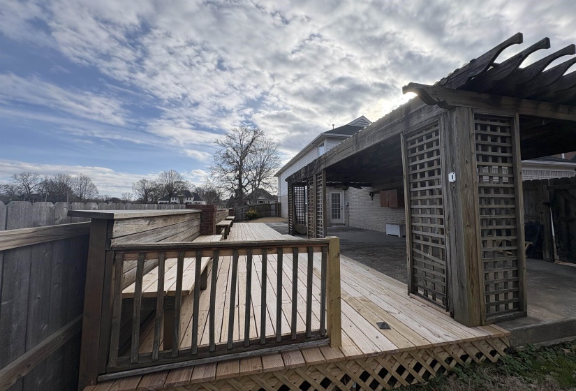 Wooden terrace with ceiling fan and a patio