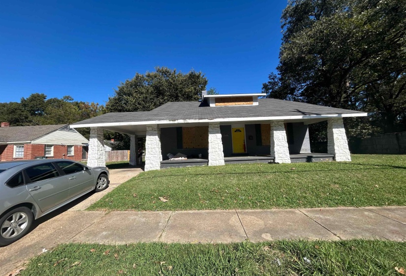 View of front facade featuring a carport and covered porch