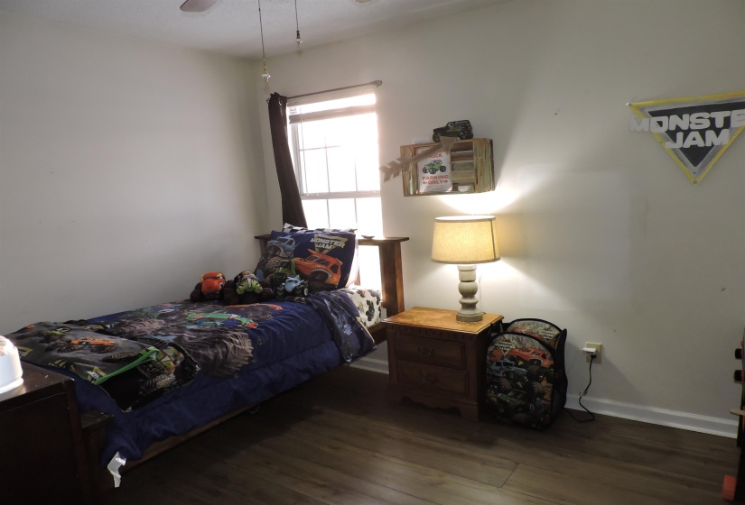 Bedroom with dark wood-style flooring and ceiling fan