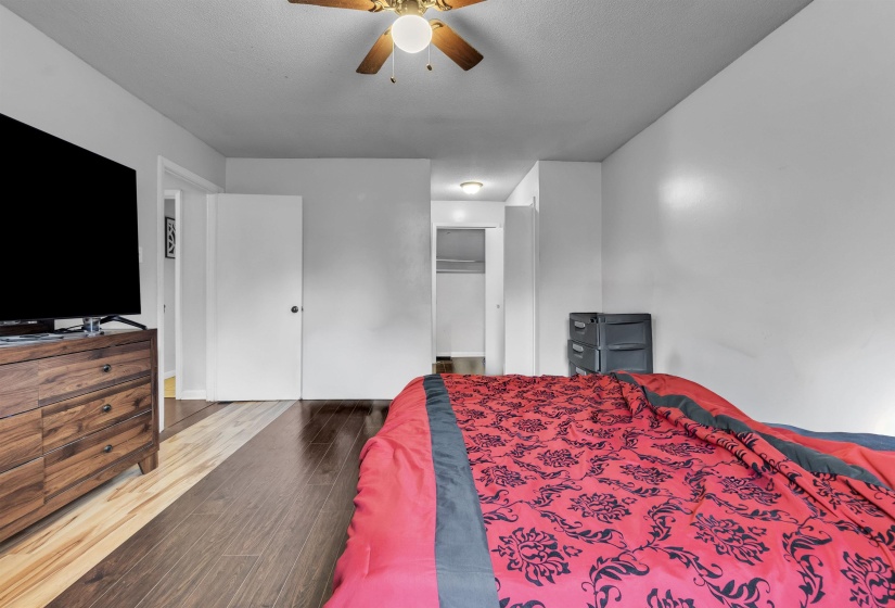 Bedroom with wood finished floors, a closet, and a ceiling fan