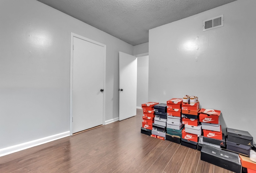 Rec room with wood finished floors and a textured ceiling