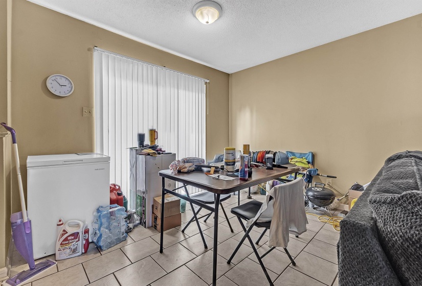 Tiled dining area featuring a textured ceiling