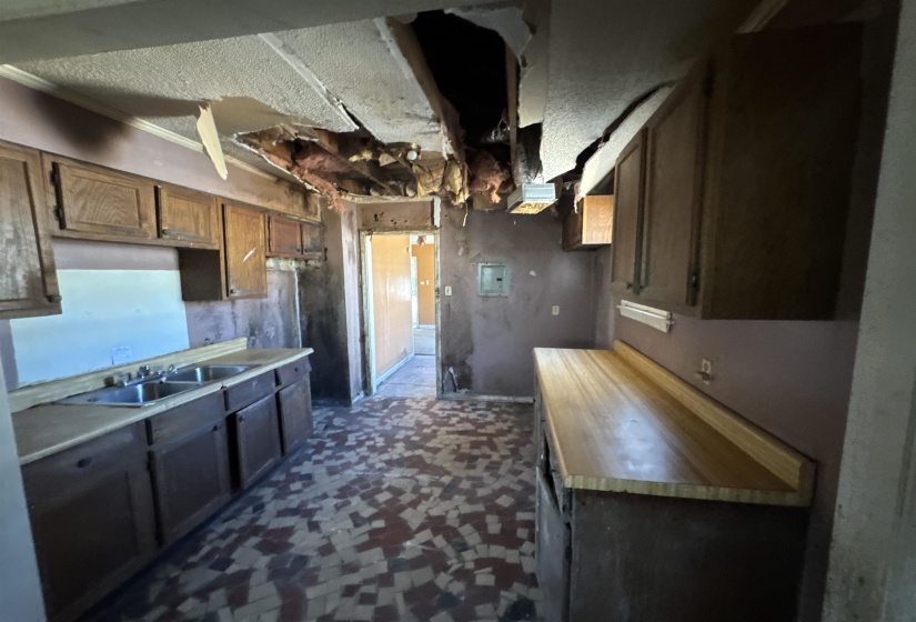 Kitchen with light countertops and a sink