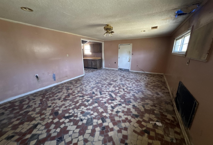 Unfurnished bedroom with a textured ceiling and baseboards