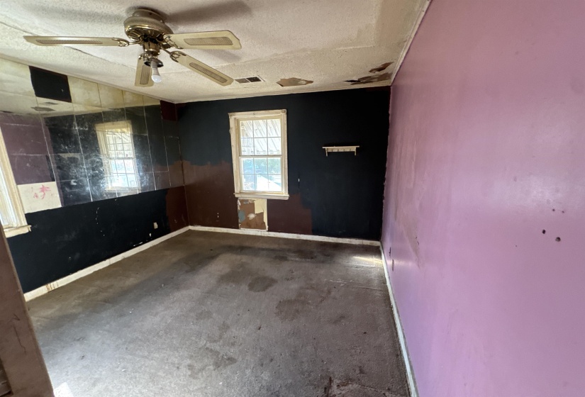 Spare room featuring a ceiling fan and a textured ceiling