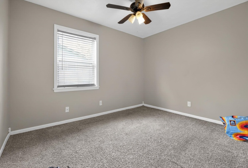 Spare room with carpet and a ceiling fan