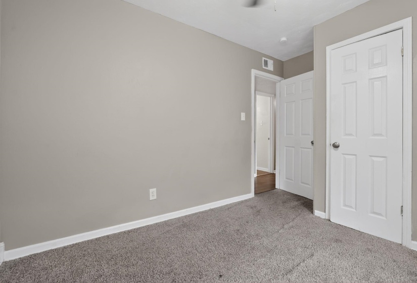Unfurnished bedroom featuring baseboards and carpet floors