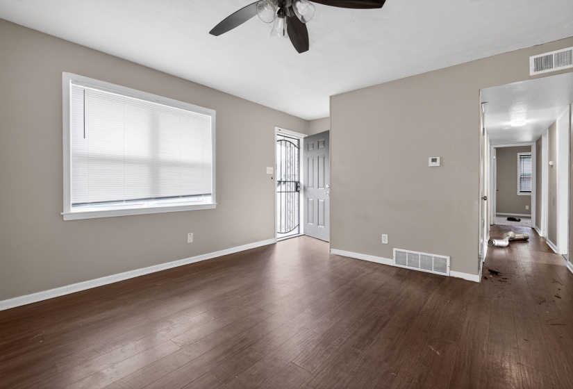 Unfurnished bedroom featuring dark wood finished floors and ceiling fan