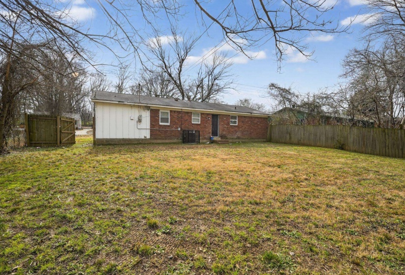Back of house featuring brick siding