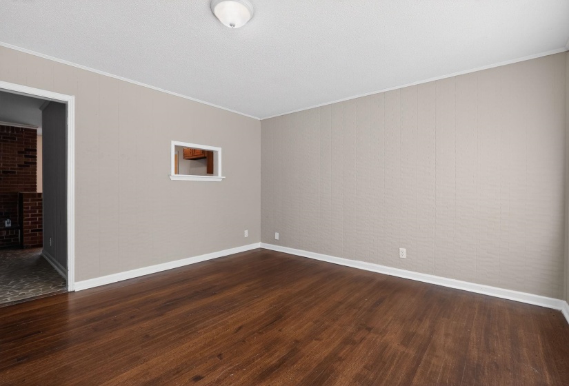 Unfurnished room featuring ornamental molding and dark wood-style floors