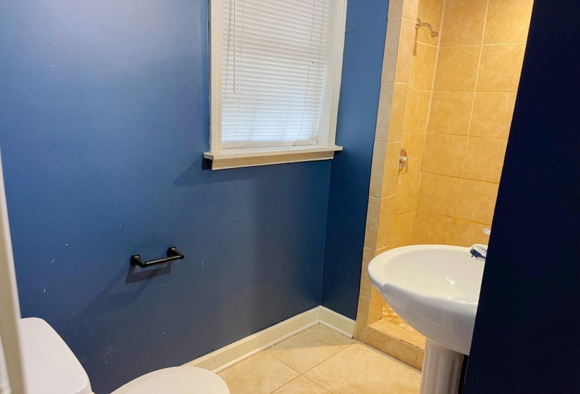 Bathroom featuring tile patterned floors and a shower