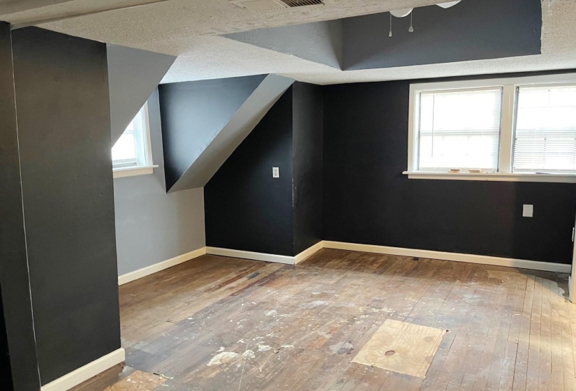Bonus room featuring a textured ceiling and light wood finished floors