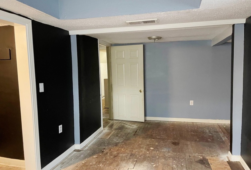 Spare room featuring a textured ceiling and hardwood / wood-style floors