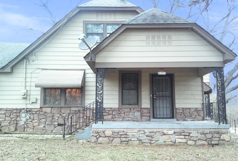 Bungalow-style home featuring a porch, stone siding, and a shingled roof