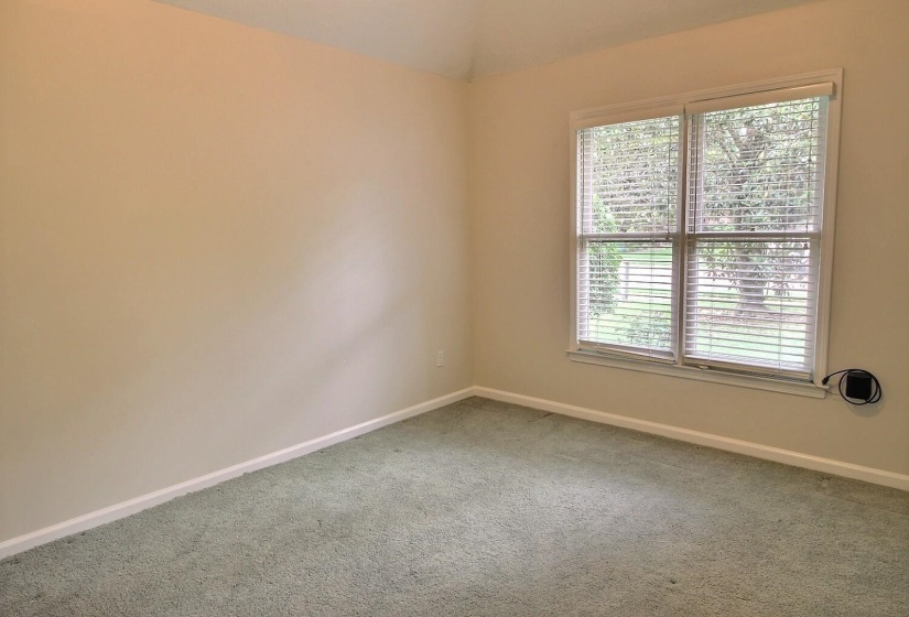 Carpeted empty room featuring baseboards