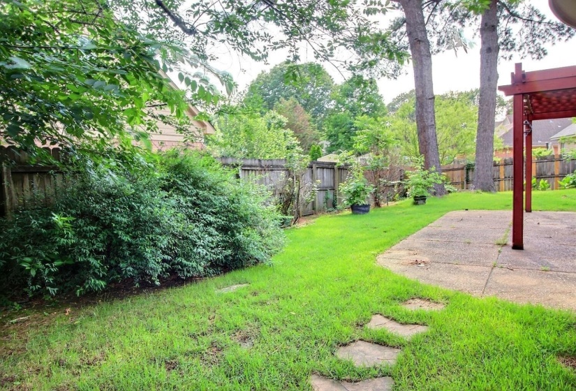 Fenced backyard with a patio area and a pergola