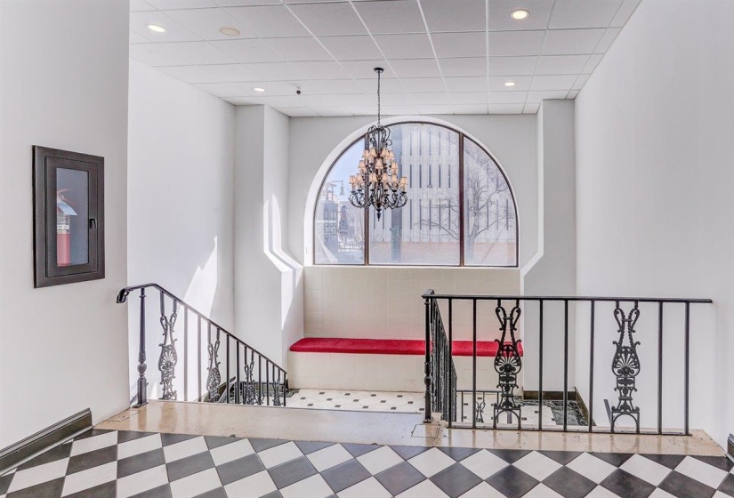 Stairs featuring a chandelier and recessed lighting