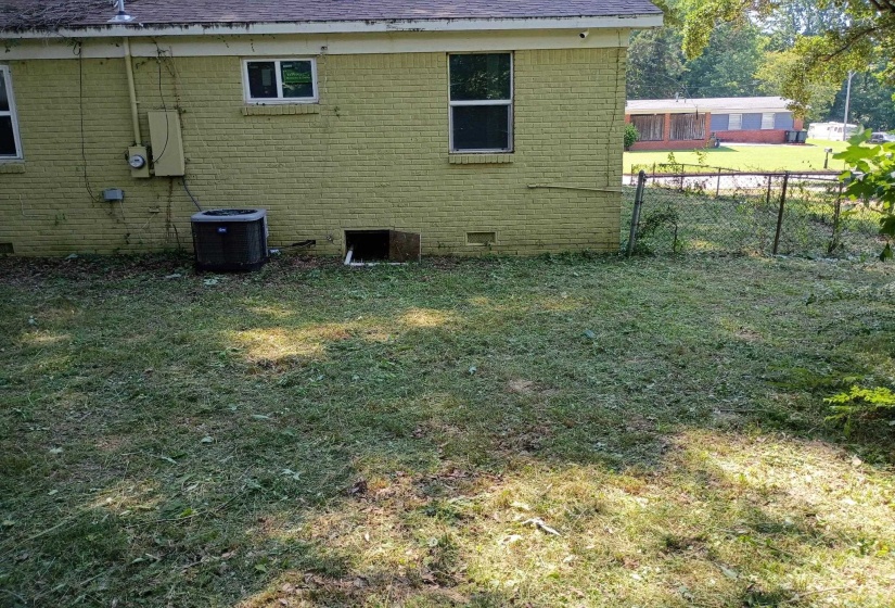 Back of property featuring brick siding, crawl space, and a shingled roof